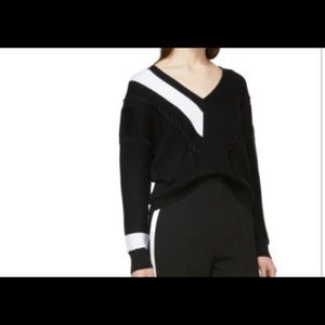 Long sleeve ribbed mercerized cotton sweater colorblocked in black and white.